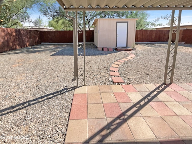 view of patio featuring a storage shed