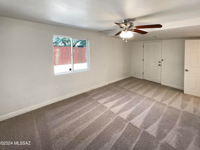 unfurnished bedroom featuring carpet, ceiling fan, and a closet