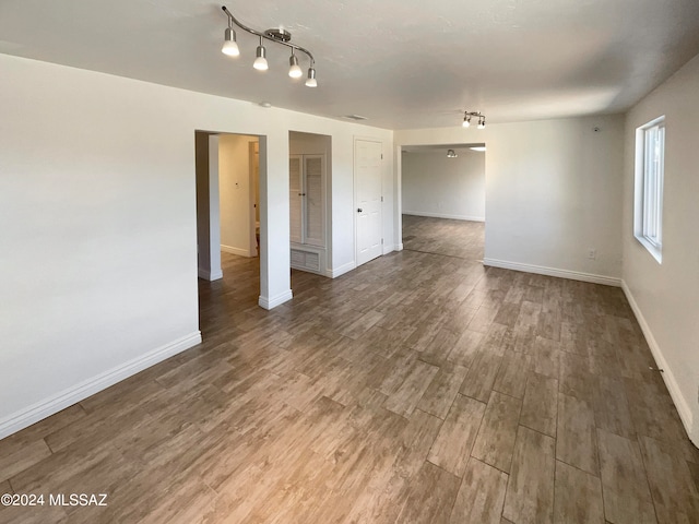 spare room with wood-type flooring