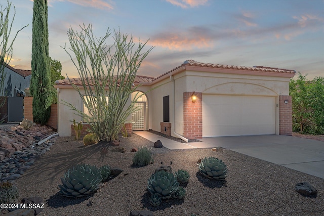 mediterranean / spanish-style home featuring a garage