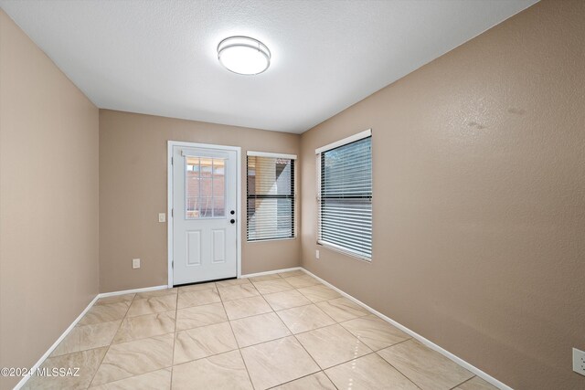 tiled spare room featuring ceiling fan and lofted ceiling