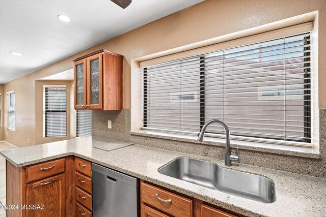 kitchen featuring backsplash, light tile patterned floors, stainless steel appliances, ceiling fan, and sink