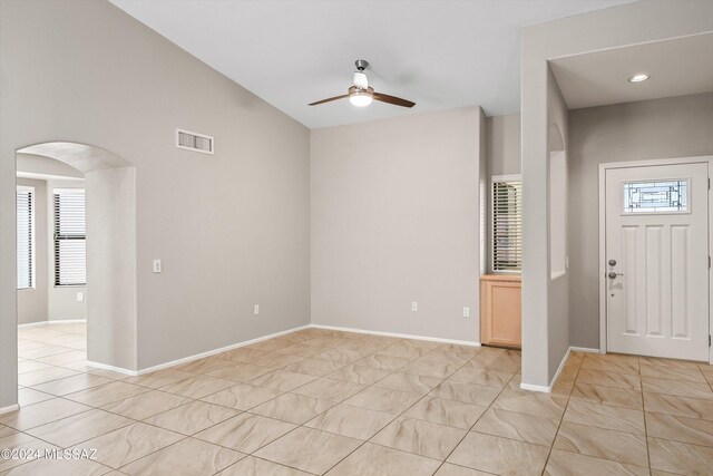 unfurnished living room with vaulted ceiling and a large fireplace