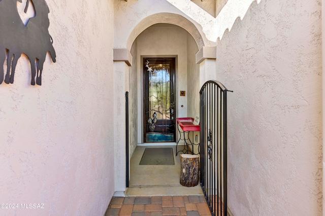 property entrance with stucco siding