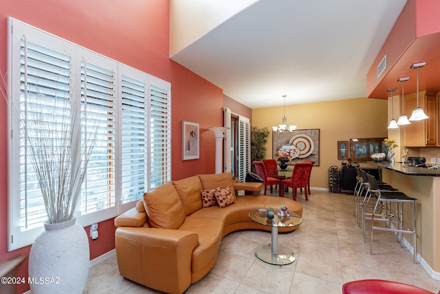 living room featuring light tile patterned floors and an inviting chandelier