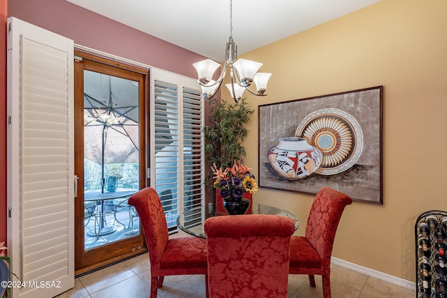 tiled dining room featuring a chandelier