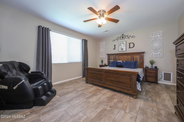 9745 S Desert Flint Dr, Tucson, AZ 85747 - bedroom featuring baseboards, a ceiling fan, light wood finished floors, and visible vents