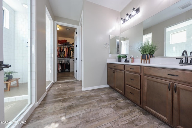 9745 S Desert Flint Dr, Tucson, AZ 85747 - bathroom with a shower stall, a sink, a spacious closet, double vanity, and visible vents