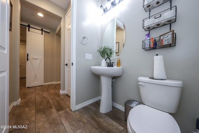 9745 S Desert Flint Dr, Tucson, AZ 85747 - bathroom with recessed lighting, wood finished floors, toilet, and baseboards