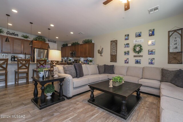 9745 S Desert Flint Dr, Tucson, AZ 85747 - living area with ceiling fan, light wood-style flooring, visible vents, and recessed lighting