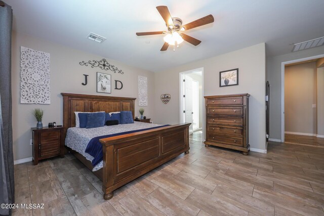 9745 S Desert Flint Dr, Tucson, AZ 85747 - bedroom with baseboards, a ceiling fan, visible vents, and light wood-style flooring