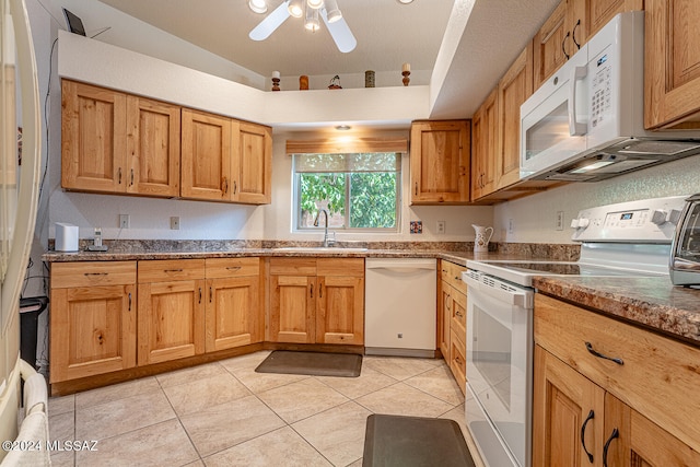 kitchen featuring light tile patterned floors, white appliances, sink, and ceiling fan