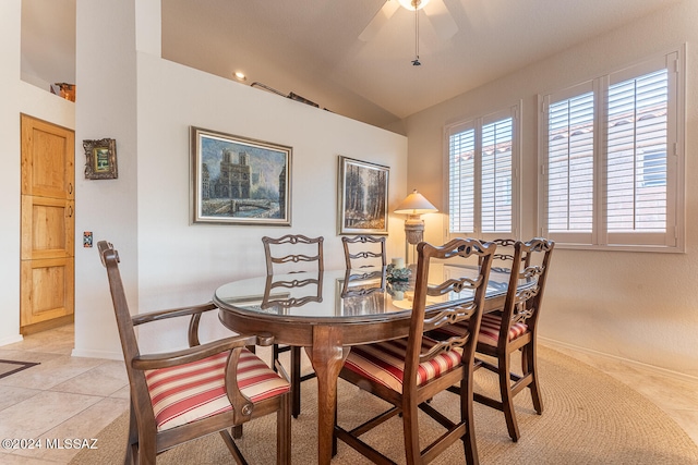 tiled dining space with lofted ceiling and ceiling fan