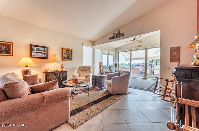 living room with ceiling fan, light tile patterned floors, and vaulted ceiling