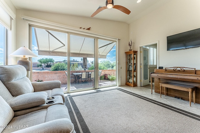 living room featuring ceiling fan, light colored carpet, and vaulted ceiling