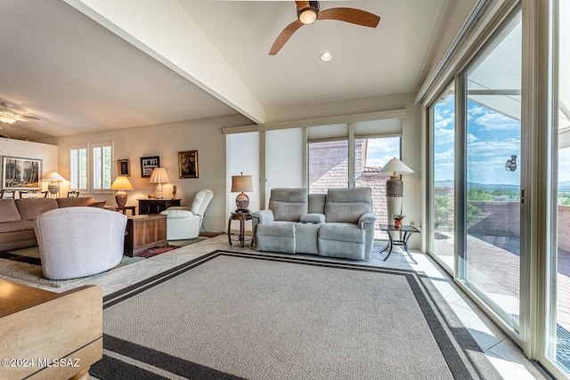 carpeted living room with ceiling fan and a healthy amount of sunlight