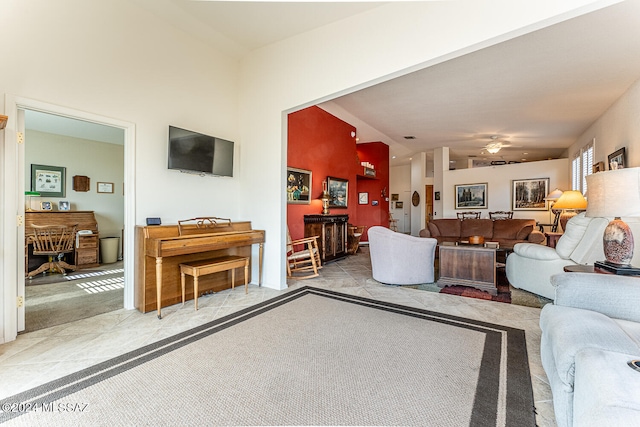 living room with ceiling fan, light carpet, and vaulted ceiling