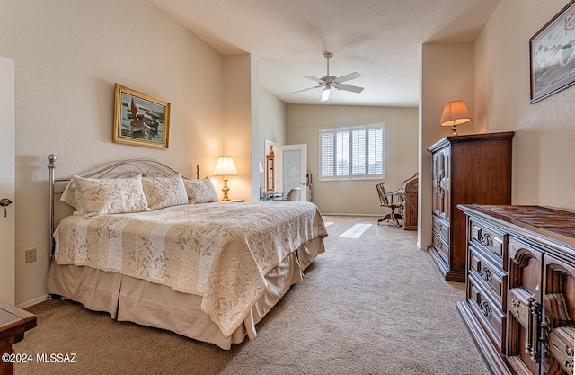 bedroom featuring vaulted ceiling, ceiling fan, and light colored carpet