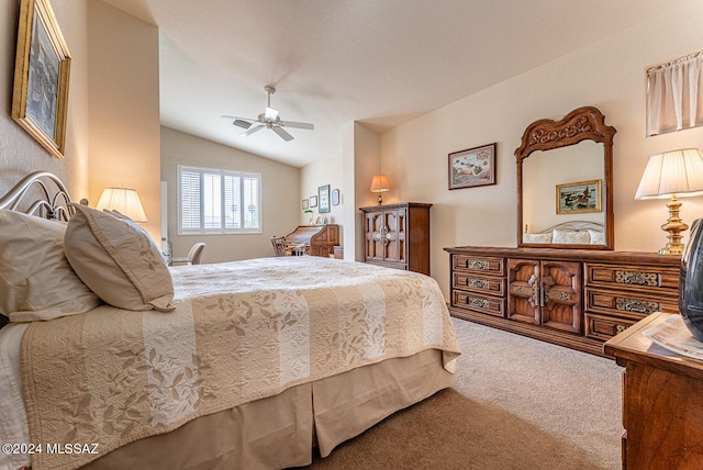 bedroom with ceiling fan, lofted ceiling, and carpet