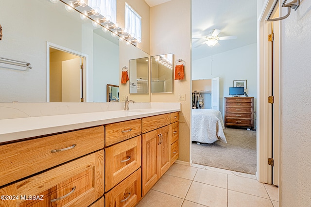 bathroom with tile patterned flooring, ceiling fan, and vanity