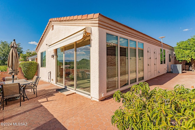 back of house with a patio and central AC