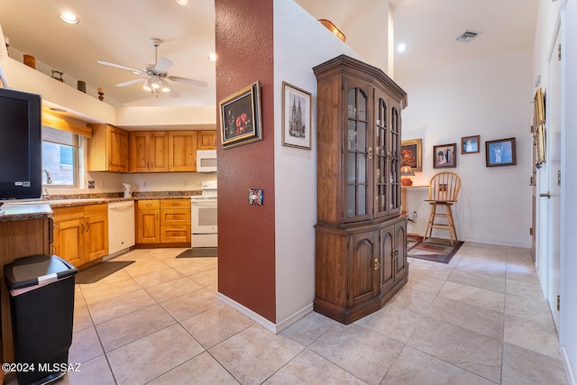 kitchen featuring light tile patterned floors, white appliances, and ceiling fan