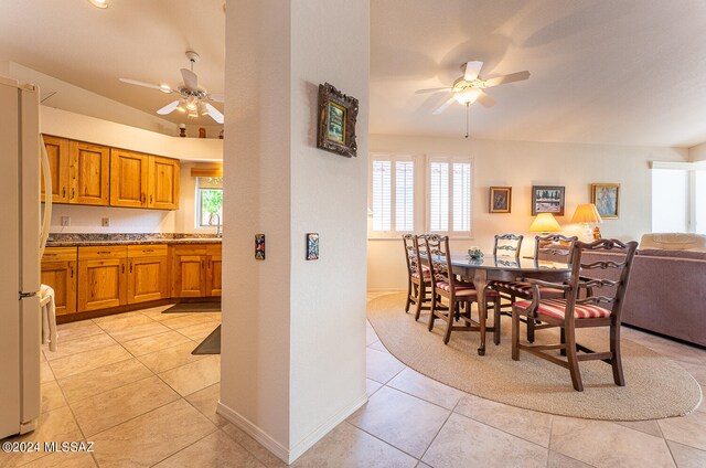 dining area featuring ceiling fan, light tile patterned floors, and a healthy amount of sunlight