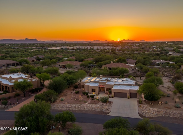 aerial view at dusk featuring a mountain view