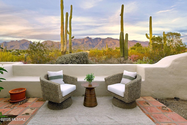 view of patio / terrace with a mountain view and a balcony