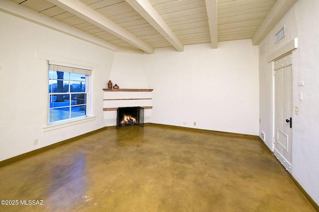 unfurnished living room with concrete flooring and beam ceiling