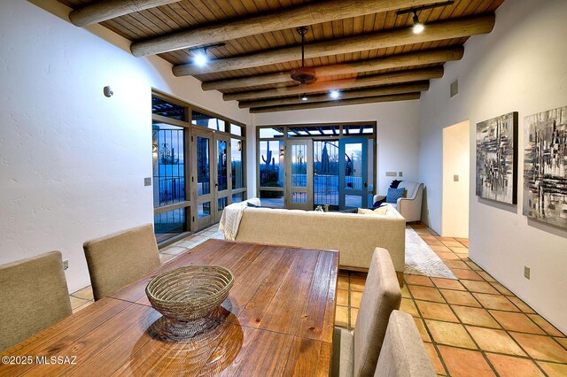 tiled dining space with beamed ceiling, rail lighting, ceiling fan, and wooden ceiling