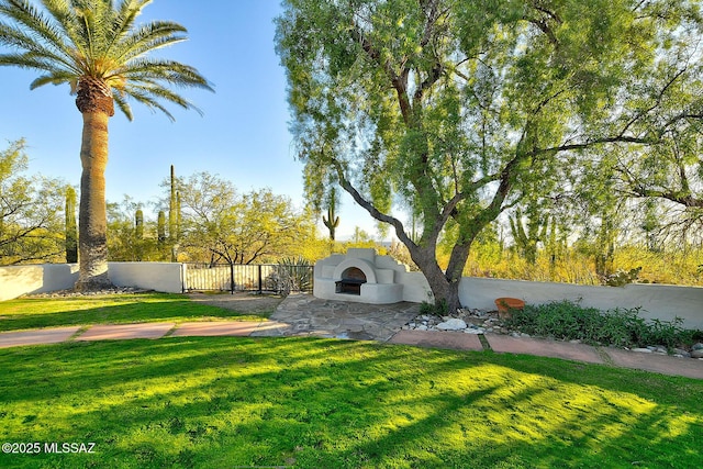 view of yard featuring exterior fireplace