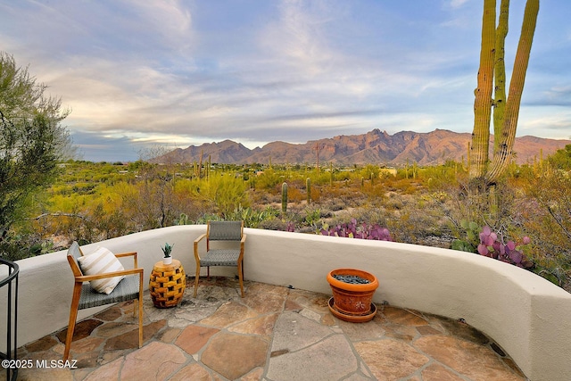 view of patio / terrace featuring a mountain view and a balcony