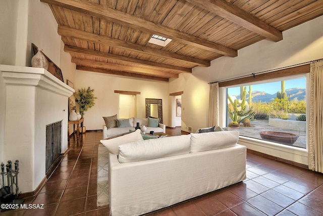 tiled living room with a mountain view, beamed ceiling, and wood ceiling