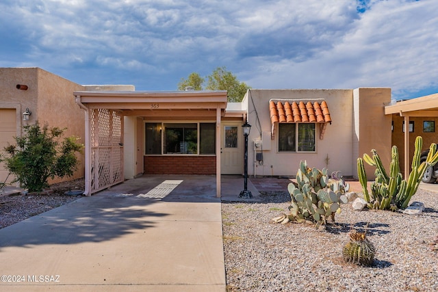 adobe home featuring a carport