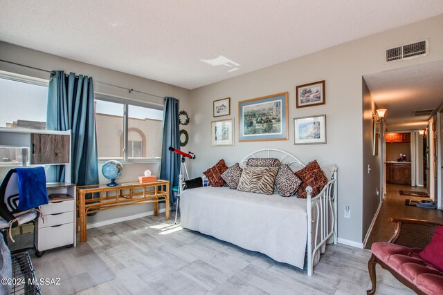 bedroom featuring a textured ceiling and built in desk