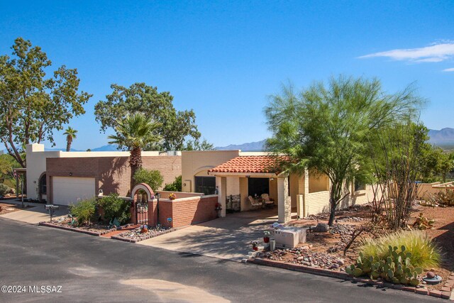 view of front of home with a garage and a mountain view