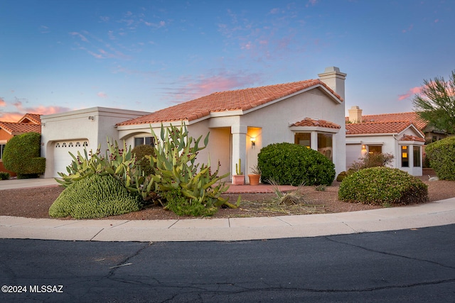 mediterranean / spanish house with a garage