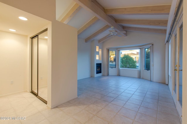 tiled spare room featuring vaulted ceiling with beams and ceiling fan