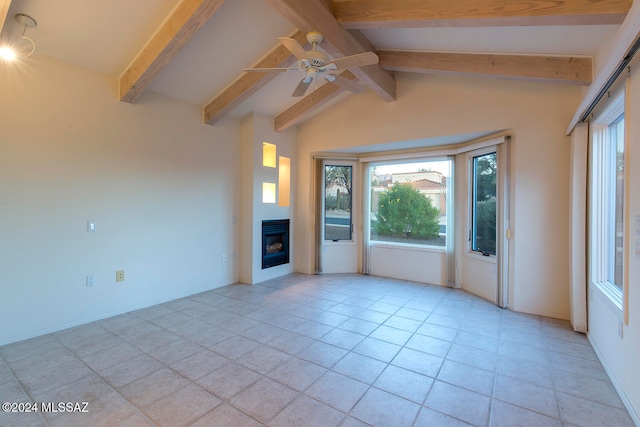 unfurnished living room with ceiling fan, light tile patterned floors, and vaulted ceiling with beams