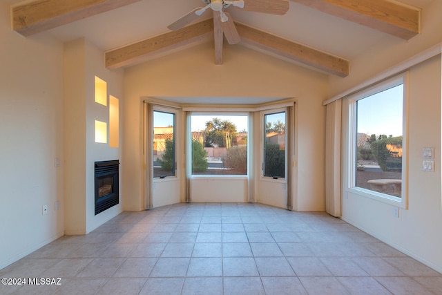 interior space featuring a wealth of natural light, lofted ceiling with beams, light tile patterned floors, and ceiling fan