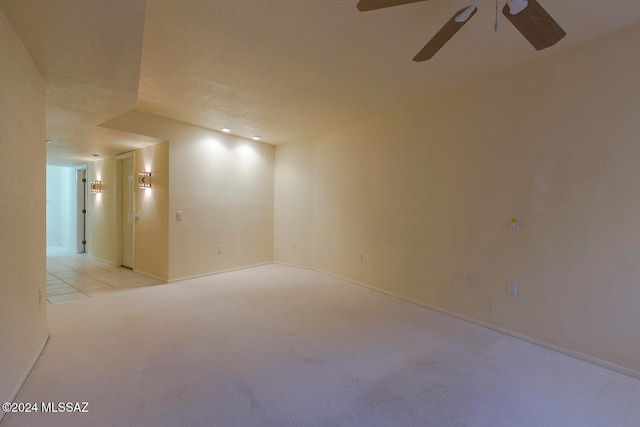 carpeted empty room with ceiling fan and a textured ceiling