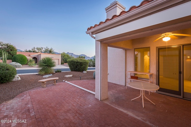 view of patio featuring a mountain view and ceiling fan