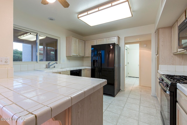 kitchen featuring black appliances, sink, ceiling fan, tile counters, and light brown cabinets