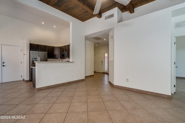 kitchen with light tile patterned flooring, high vaulted ceiling, appliances with stainless steel finishes, dark brown cabinetry, and wooden ceiling