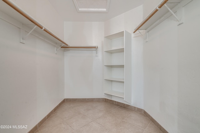 spacious closet with light tile patterned floors