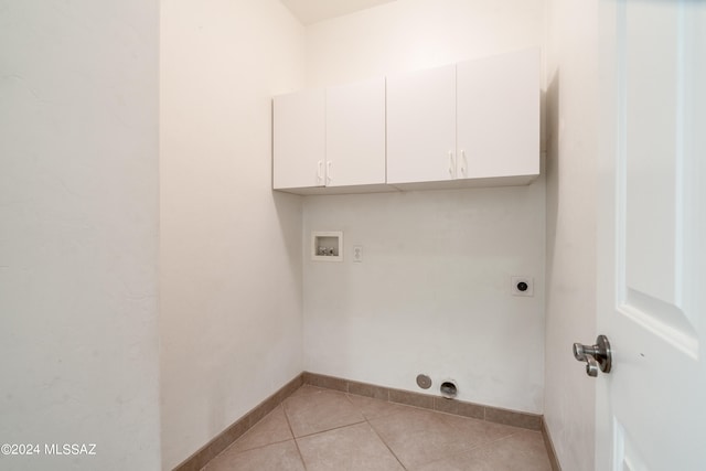 washroom with light tile patterned floors, washer hookup, electric dryer hookup, and cabinets