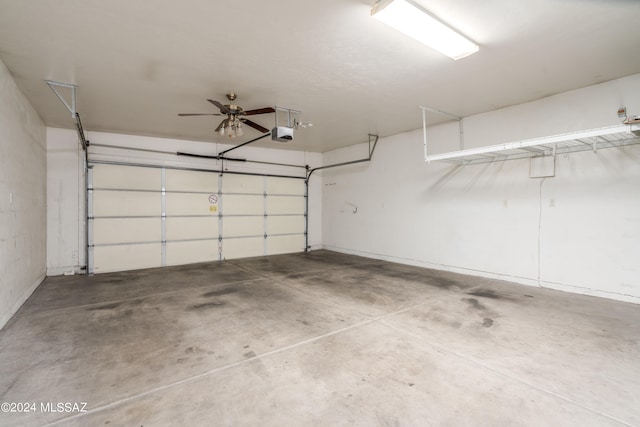 garage with ceiling fan and a garage door opener