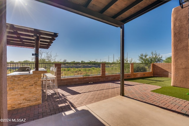 view of patio with an outdoor bar