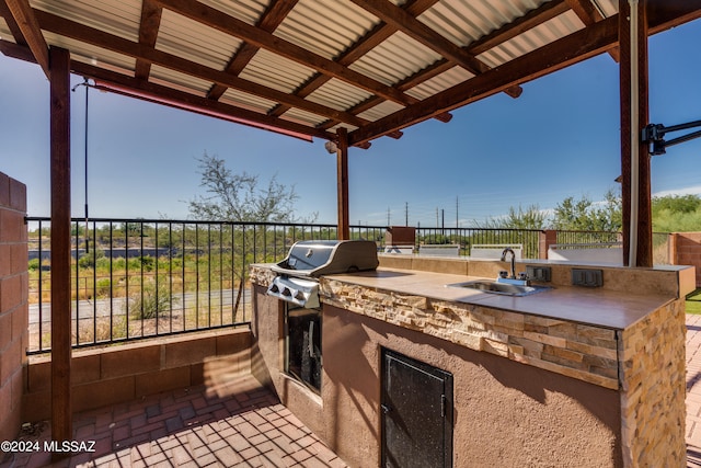 view of patio / terrace with area for grilling, sink, and an outdoor kitchen